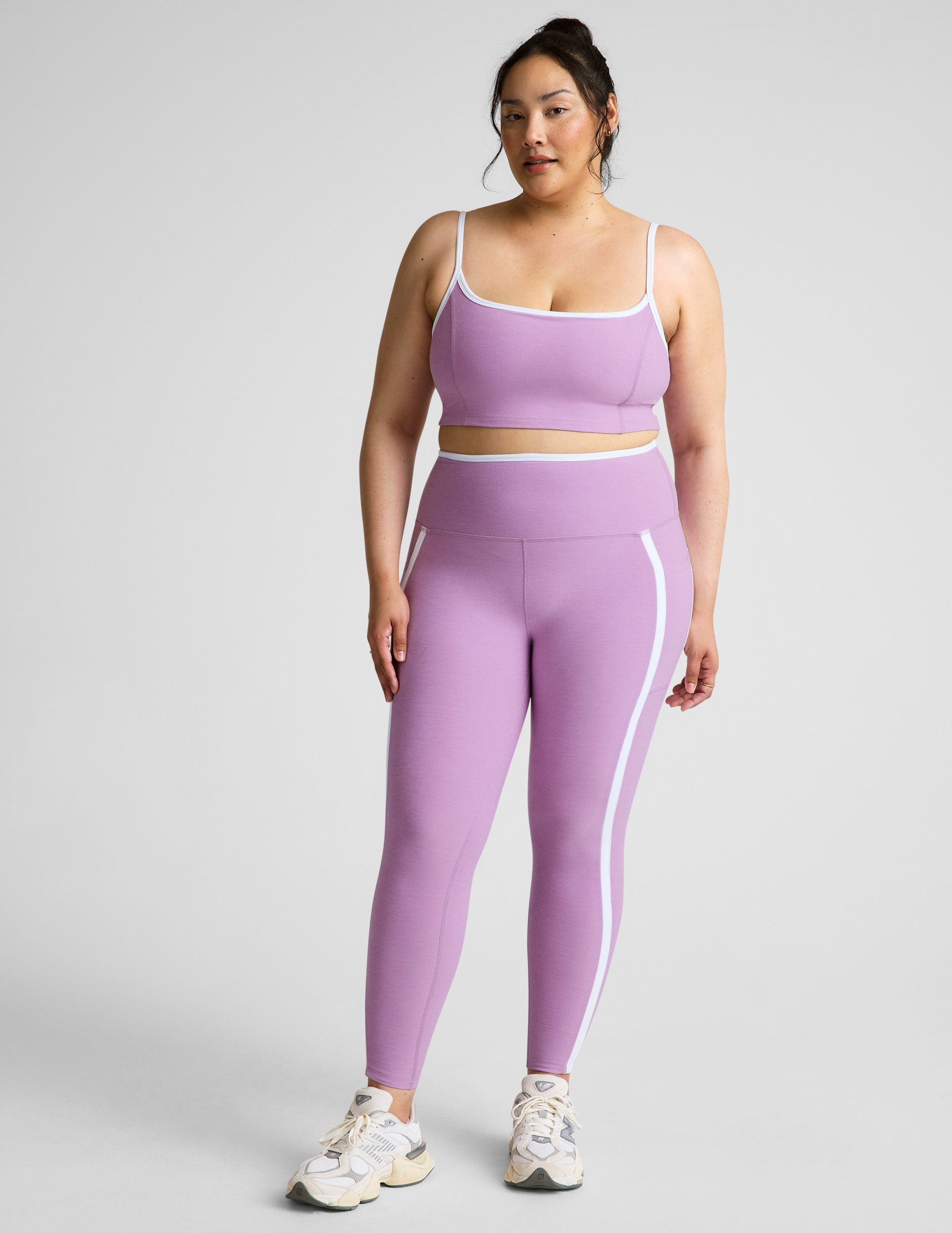 purple cropped tank with princess seams and white piping along edges.