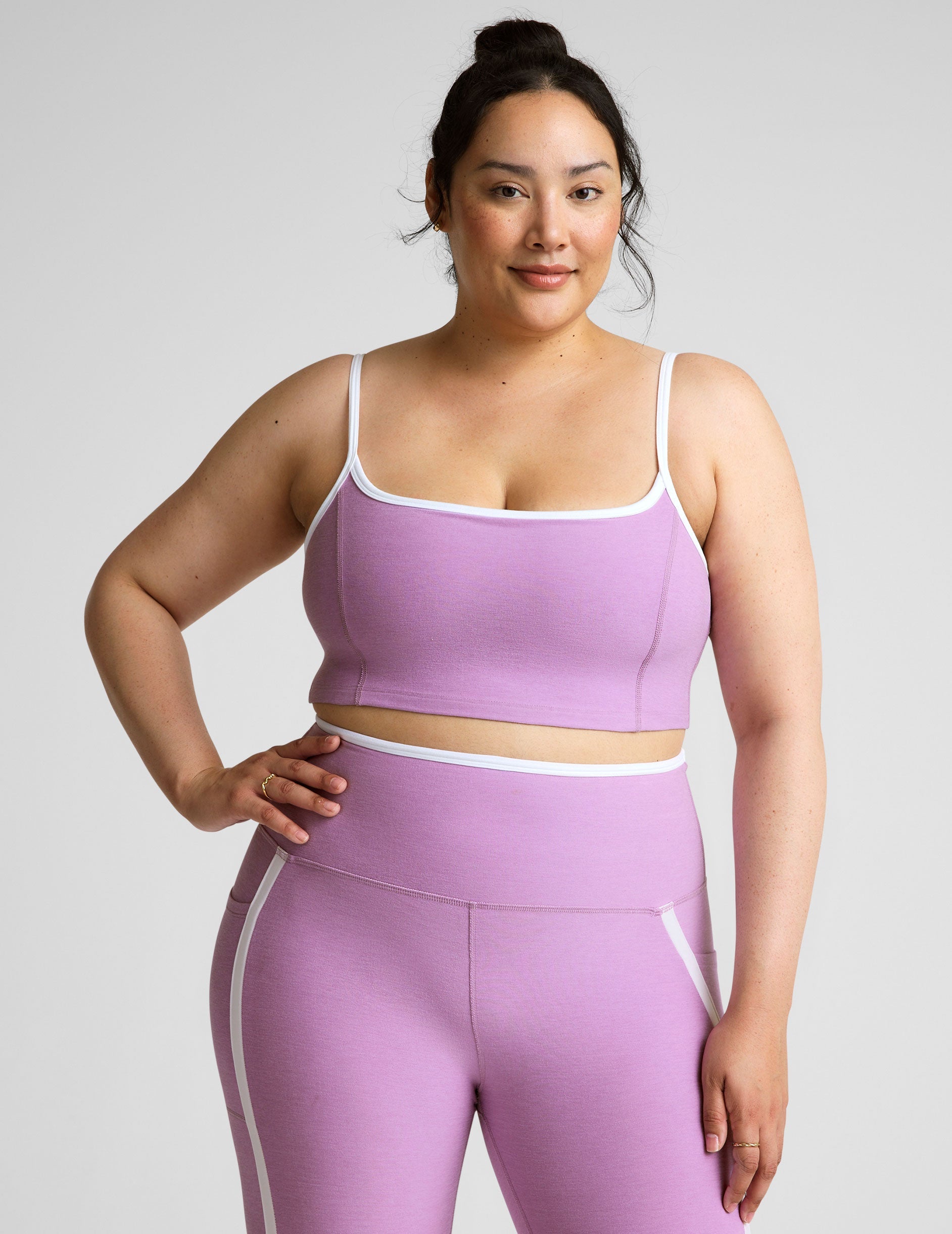 purple cropped tank with princess seams and white piping along edges.