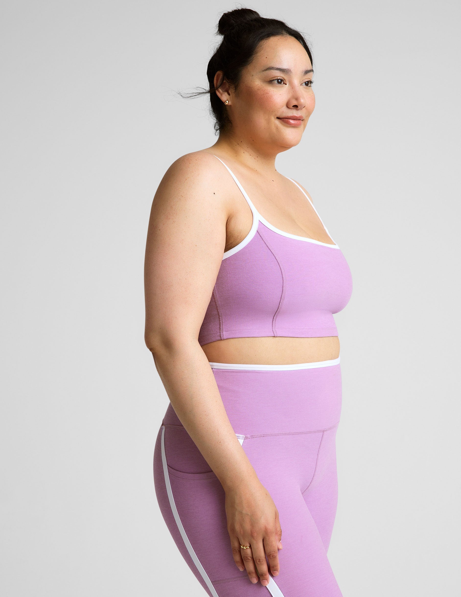 purple cropped tank with princess seams and white piping along edges.