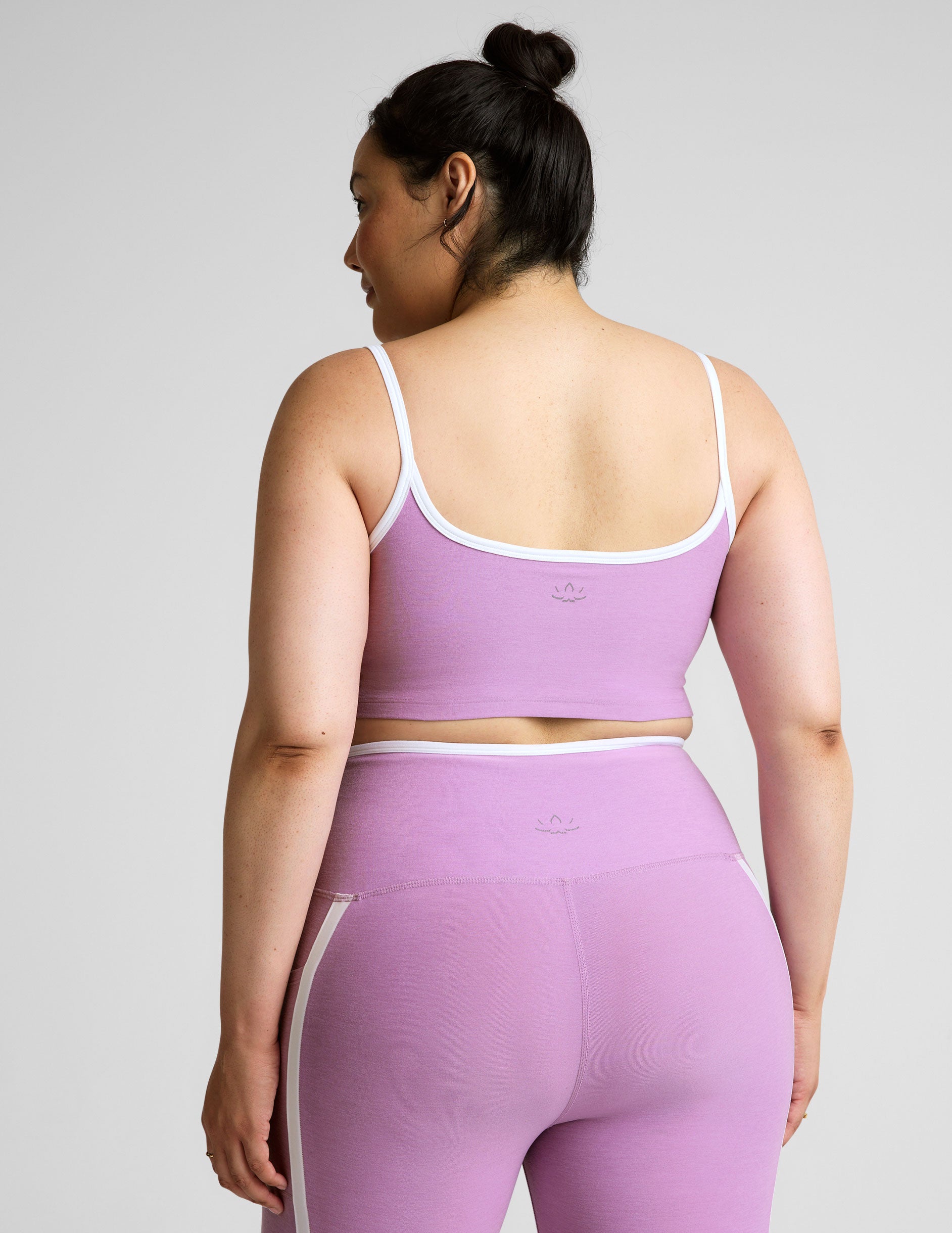 purple cropped tank with princess seams and white piping along edges.