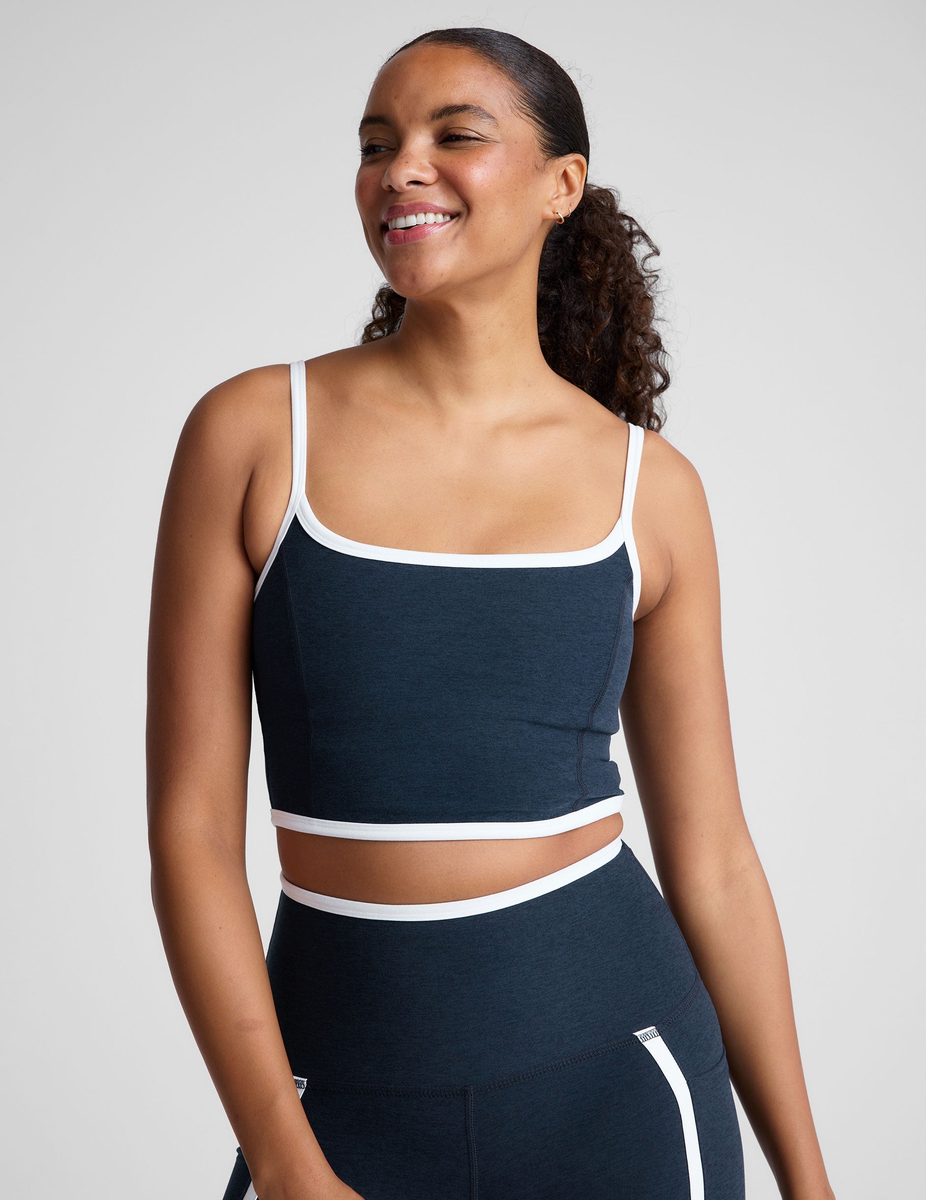 blue cropped tank with princess seams and white piping along edges.