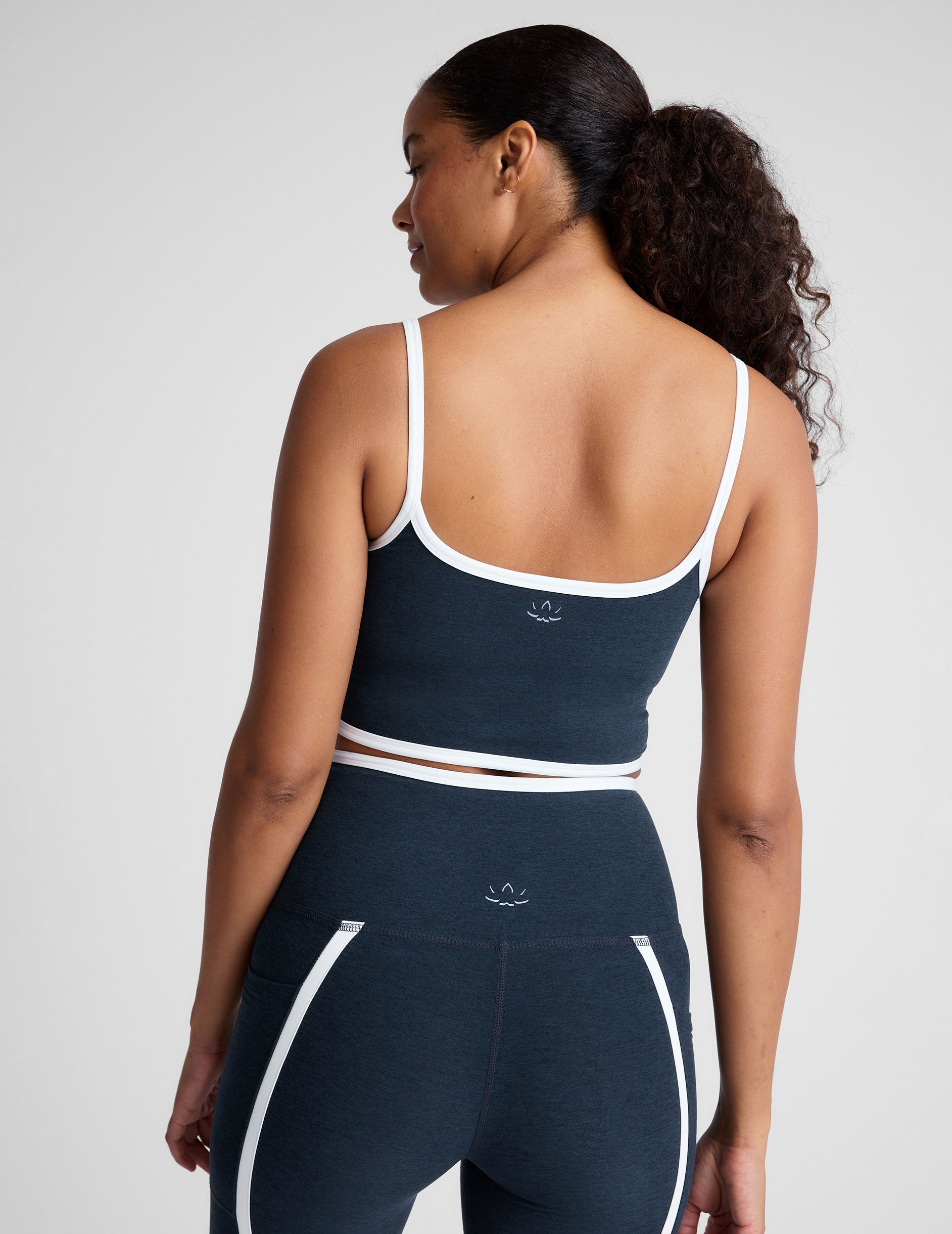 blue cropped tank with princess seams and white piping along edges.