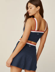 blue square neck cropped tank top with white and red stripes and outlining around the neckline.