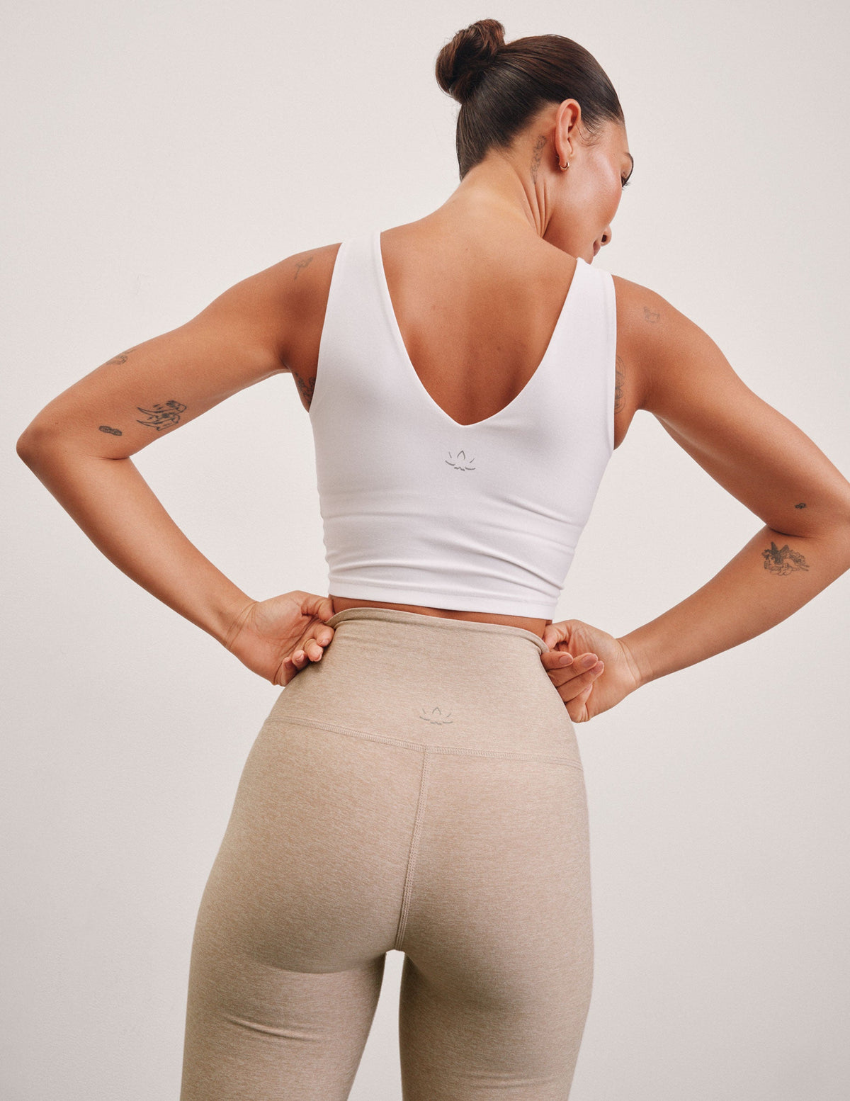 white cropped tank with a front and back v neckline.