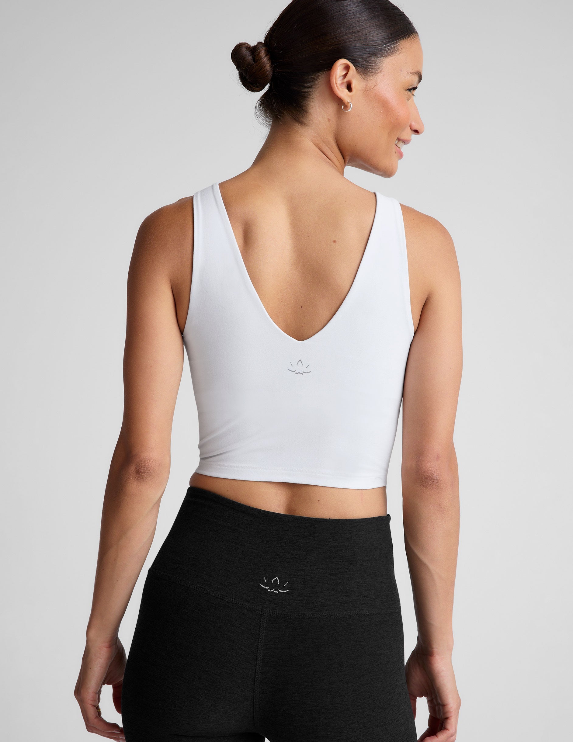 white cropped tank with a front and back v neckline.