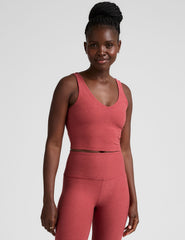 red cropped tank top with a front and back v neckline.