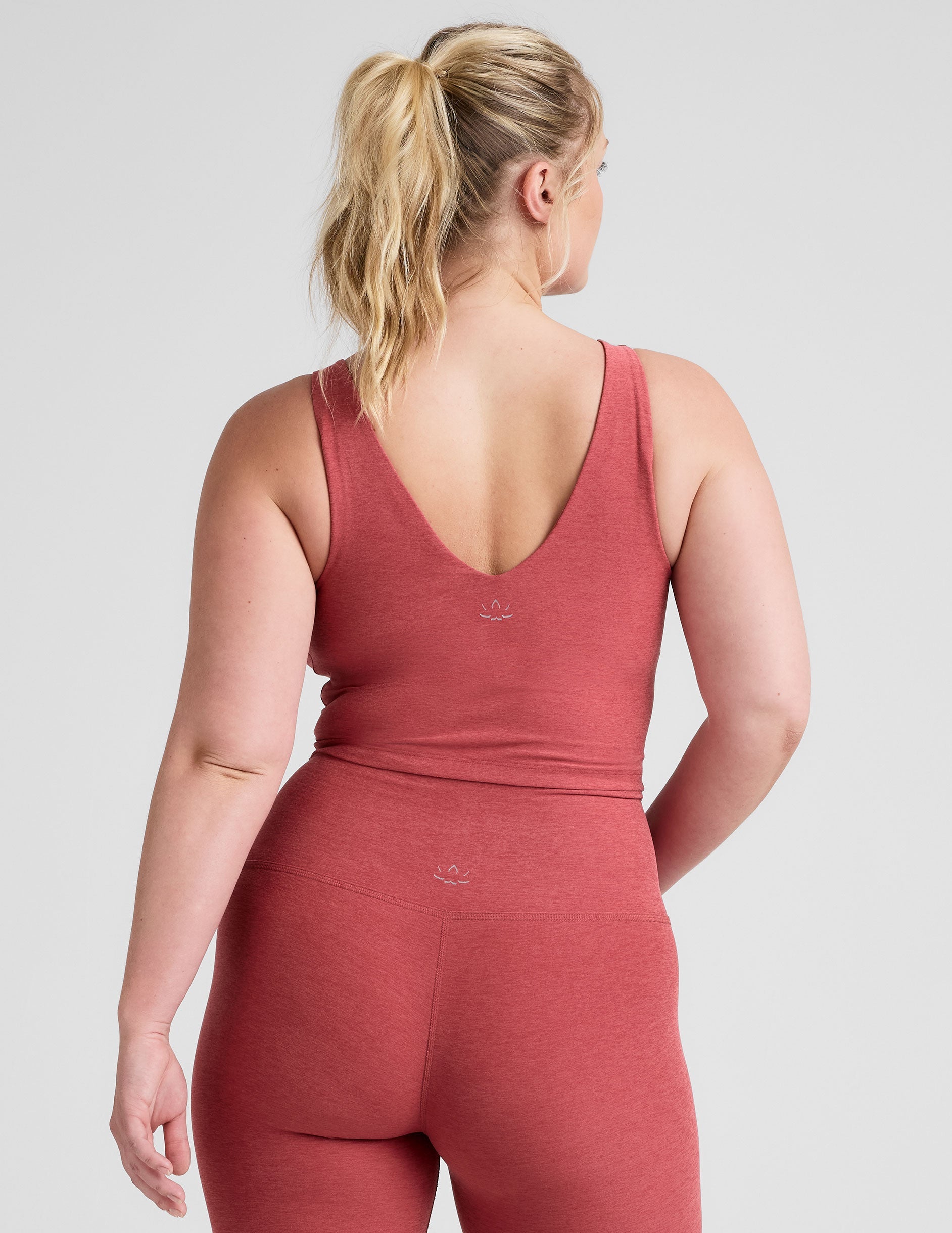 red cropped tank top with a front and back v neckline.