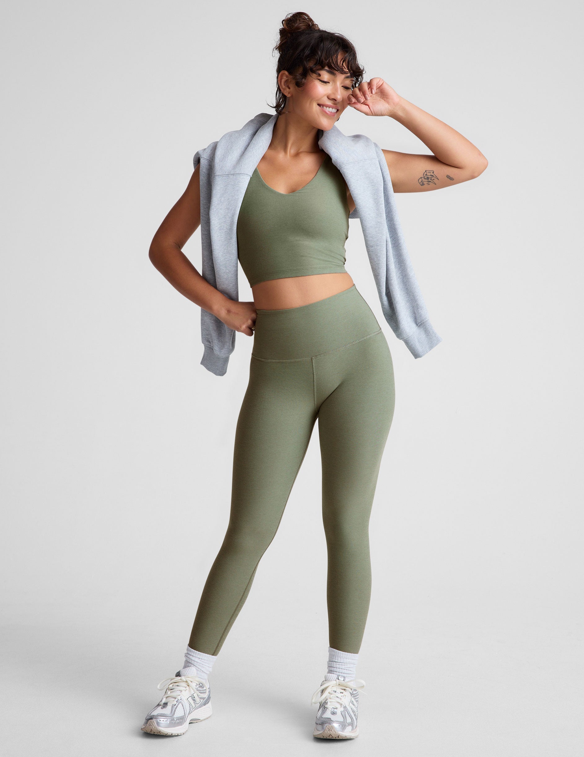 green high-waisted midi length leggings.