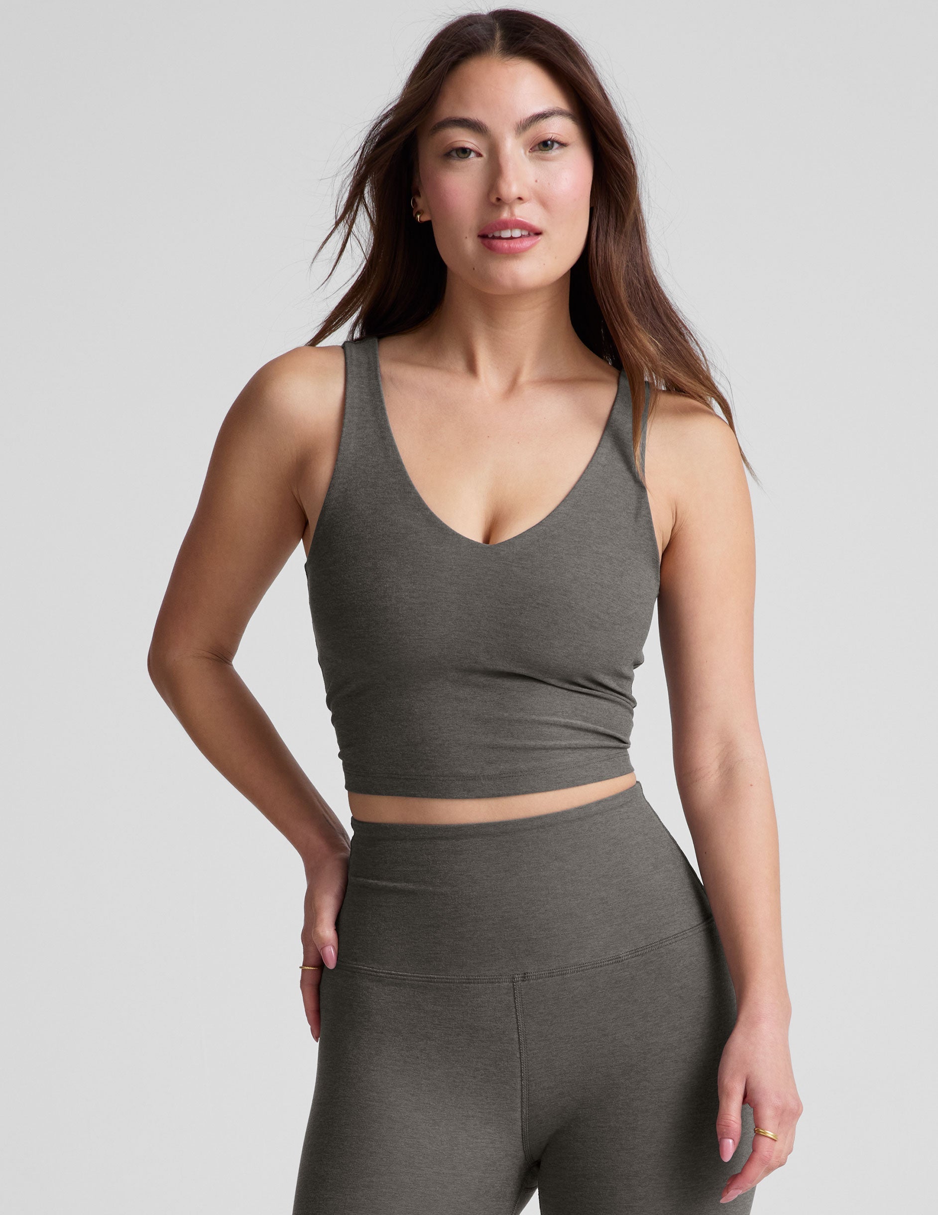 gray cropped length tank top with a front and back V neckline and self shelf bra. paired with high-waisted 5" inseam length biker shorts. 