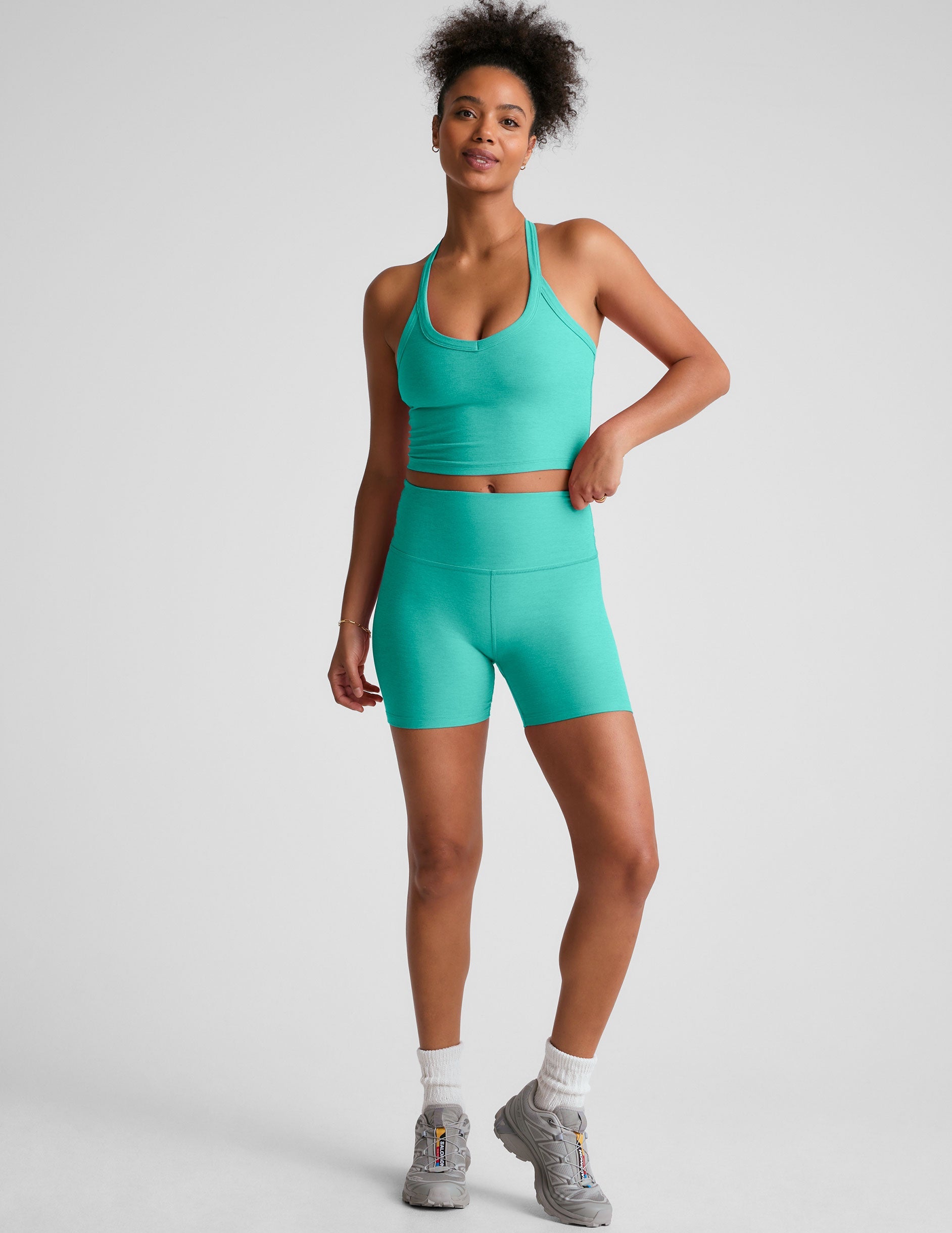 blue v-neck cropped tank top with a wide racerback detail.