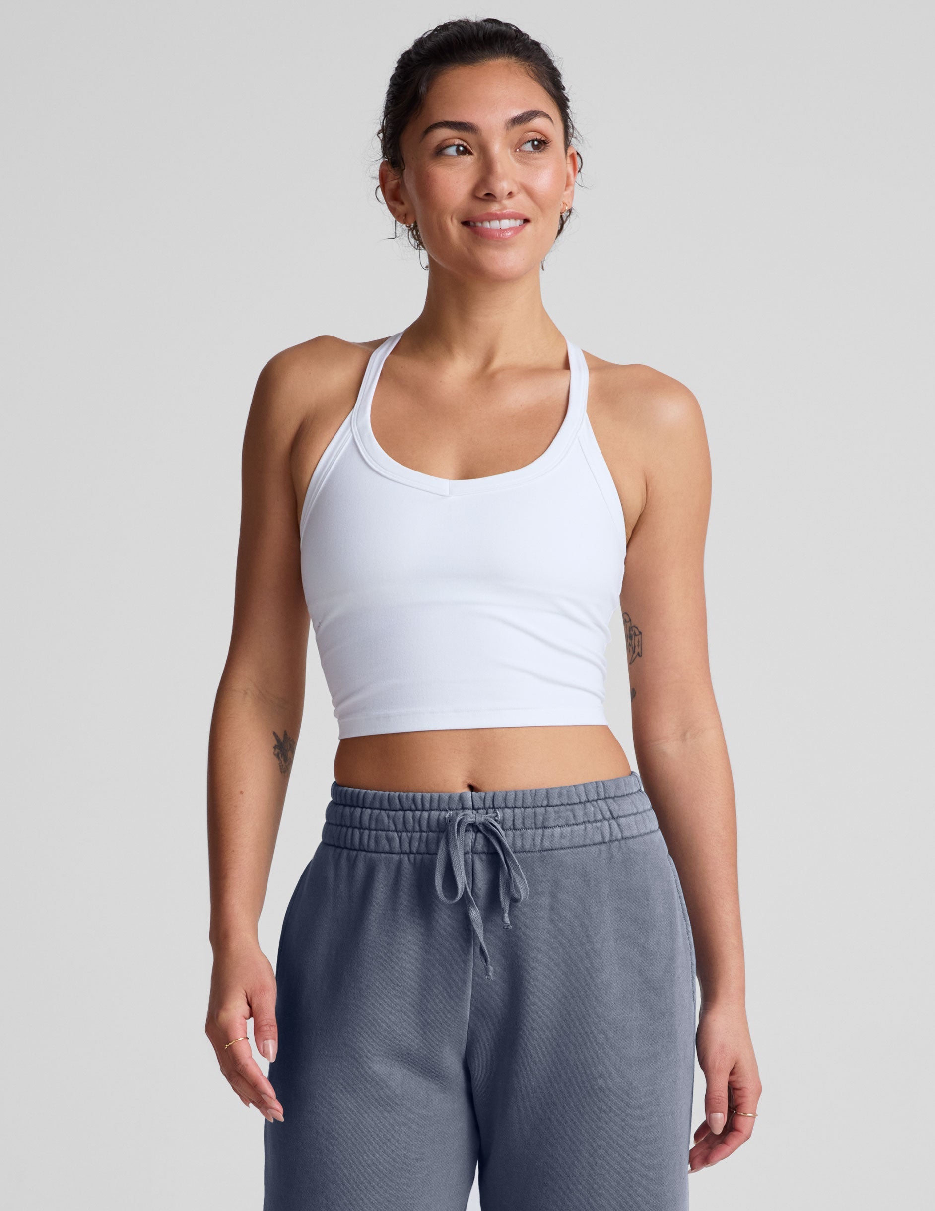 white cropped tank top with a v neckline and high racerback.
