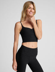 black cropped tank with shirred detailing at center front, sweetheart neckline, and adjustable straps. 