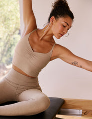 brown cropped tank with shirred detailing at center front, sweetheart neckline, and adjustable straps. 