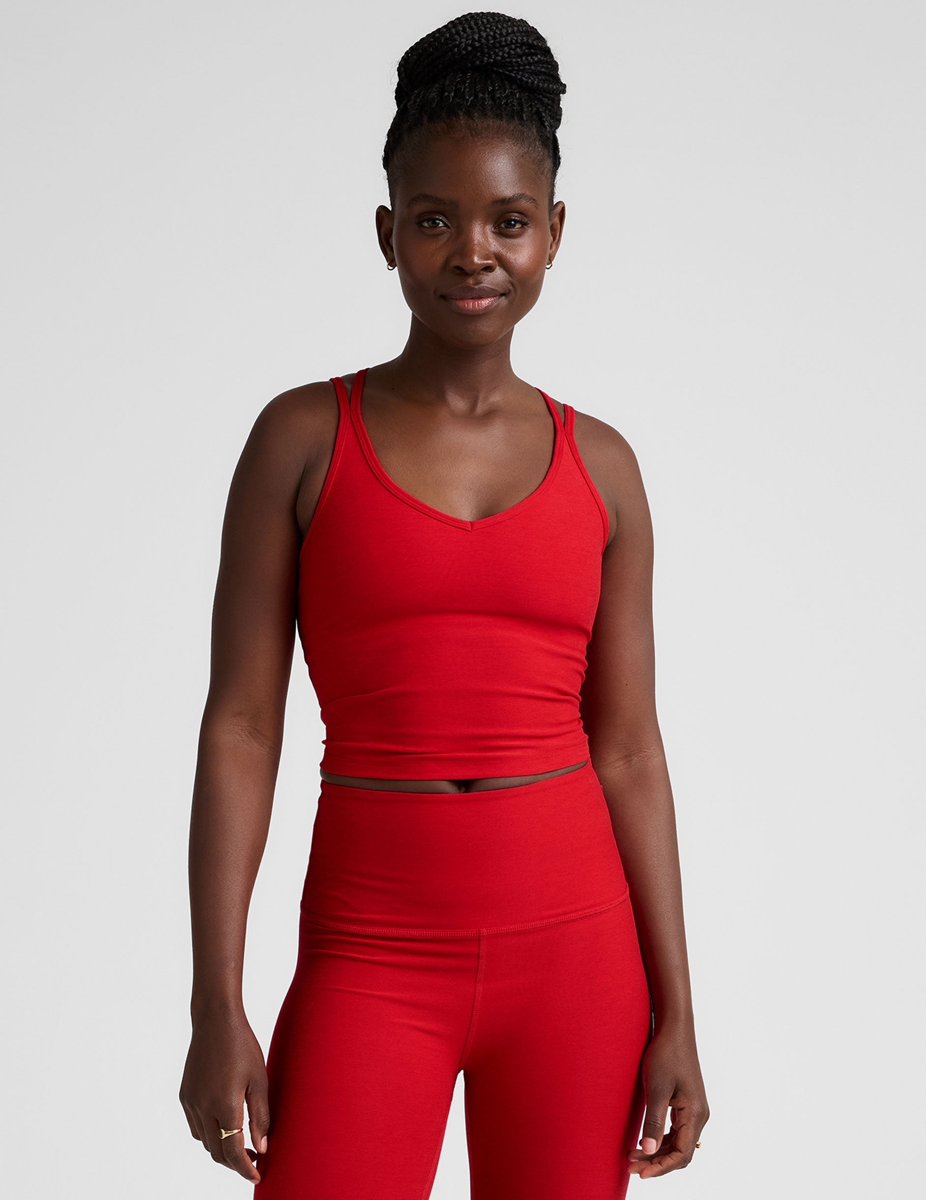 red v-neck cropped tank top with back crossover straps.