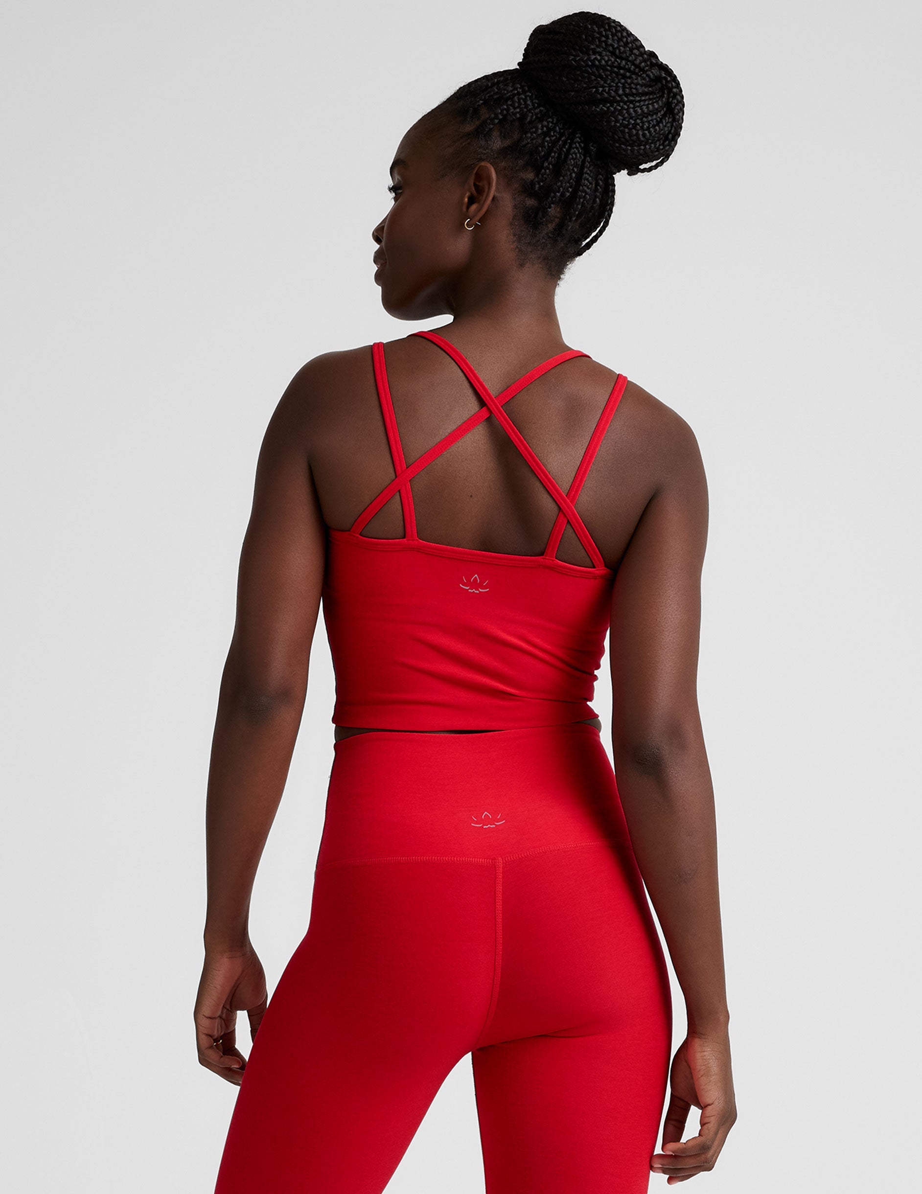 red v-neck cropped tank top with back crossover straps.
