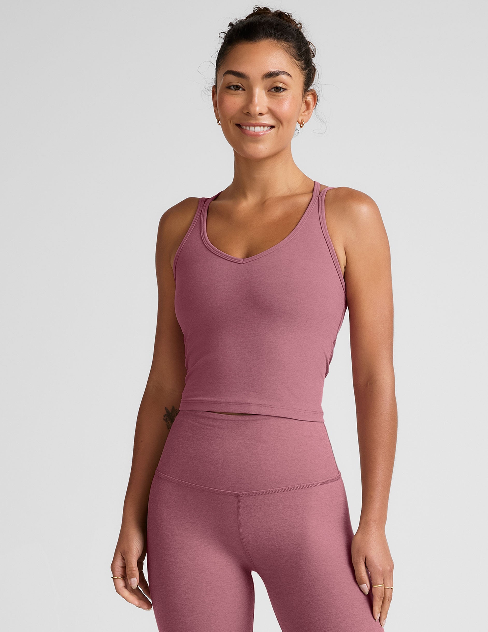 pink v-neck tank top with criss cross back straps.