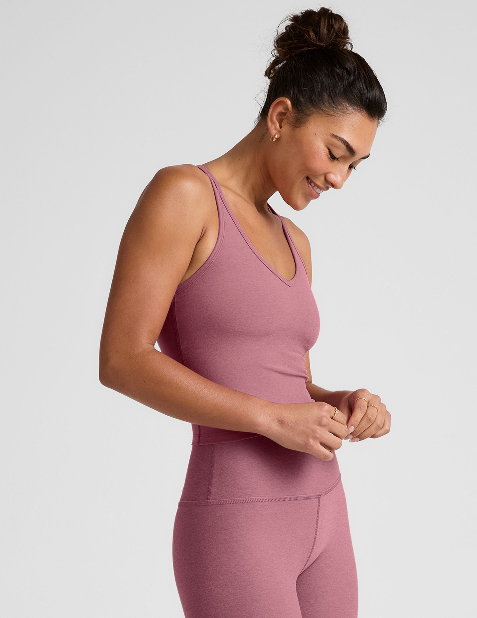 pink v-neck tank top with criss cross back straps.