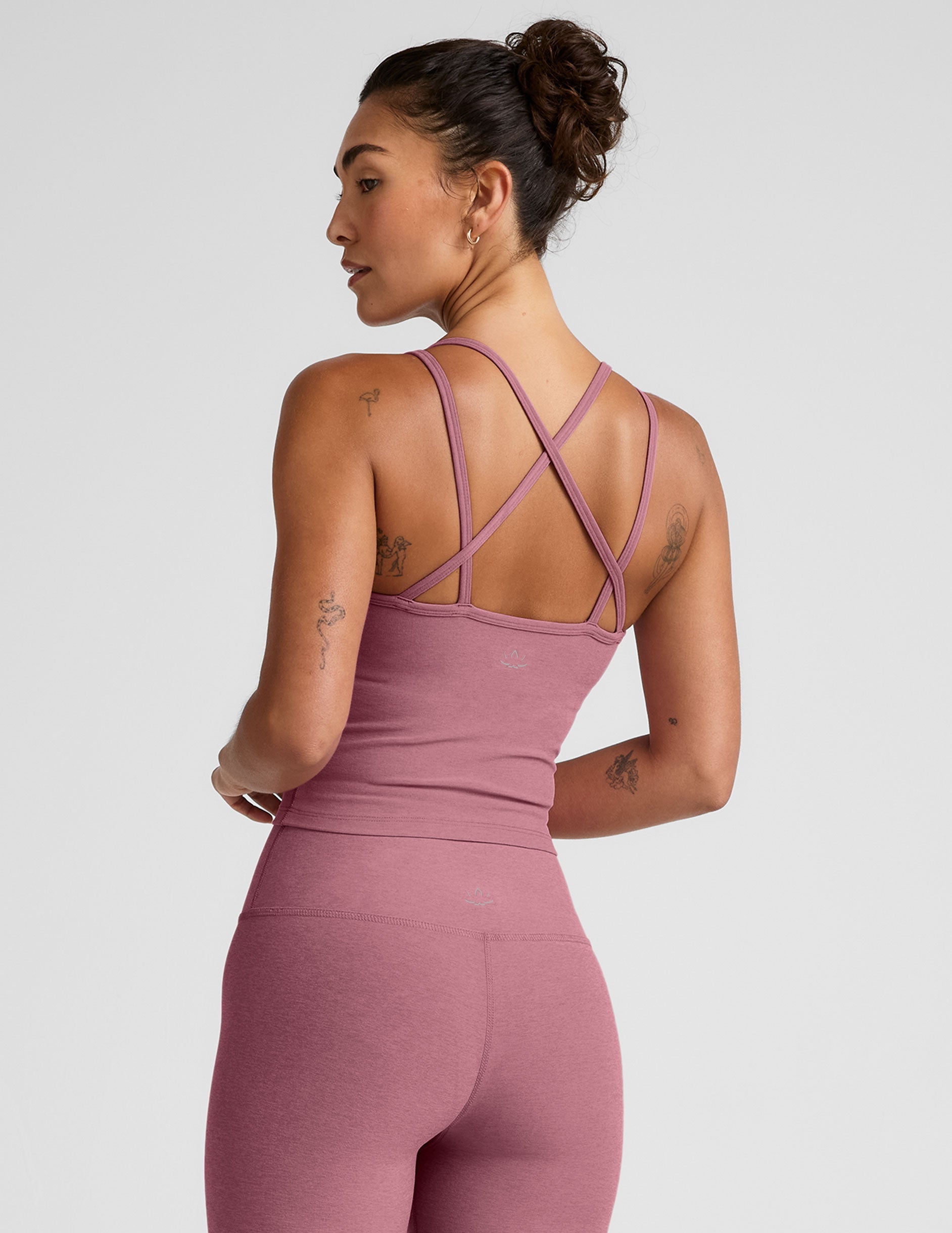 pink v-neck tank top with criss cross back straps.