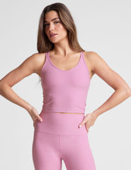 pink waist length, V neckline​ tank top with a self shelf bra and criss-cross strap back detail​. 