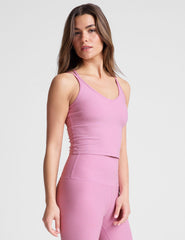pink waist length, V neckline​ tank top with a self shelf bra and criss-cross strap back detail​. 