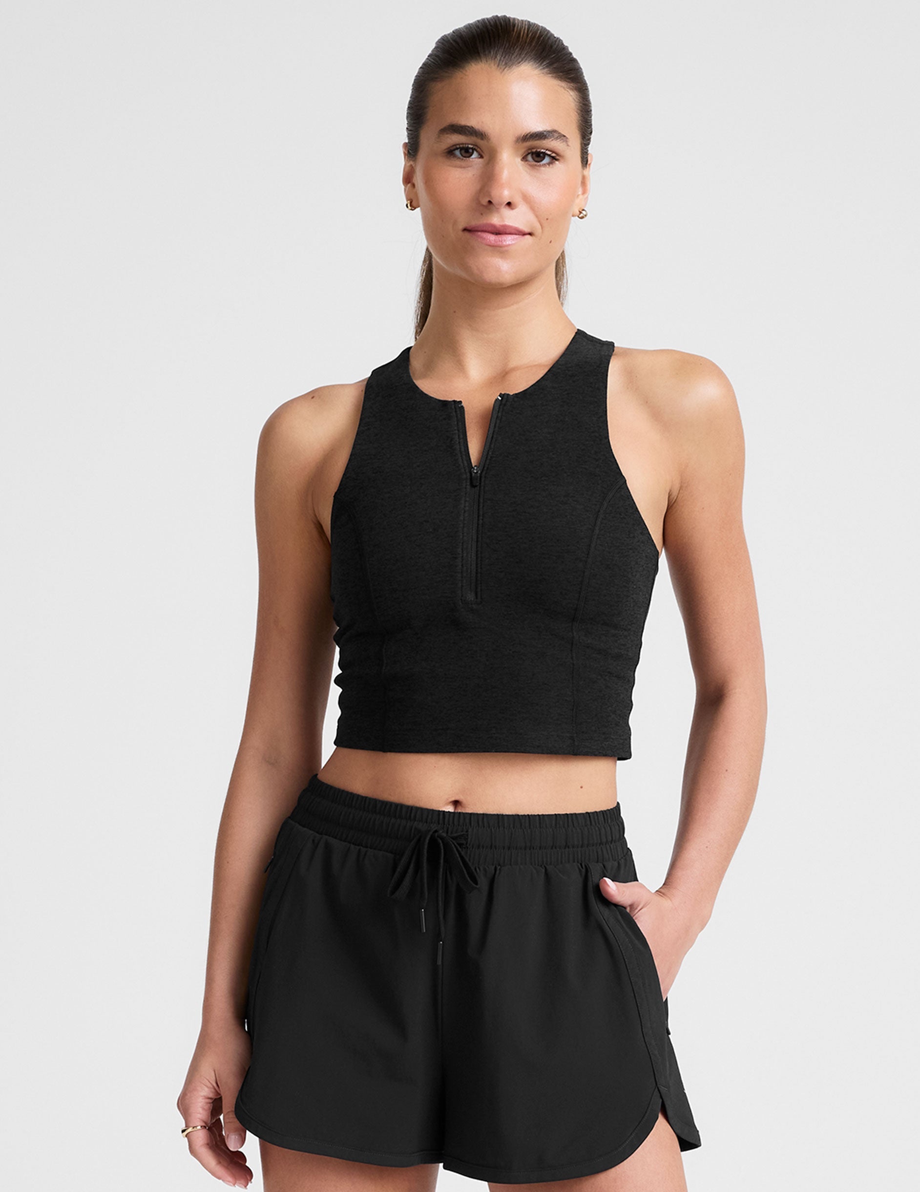 black cropped tank with a high neck with center front zipper.