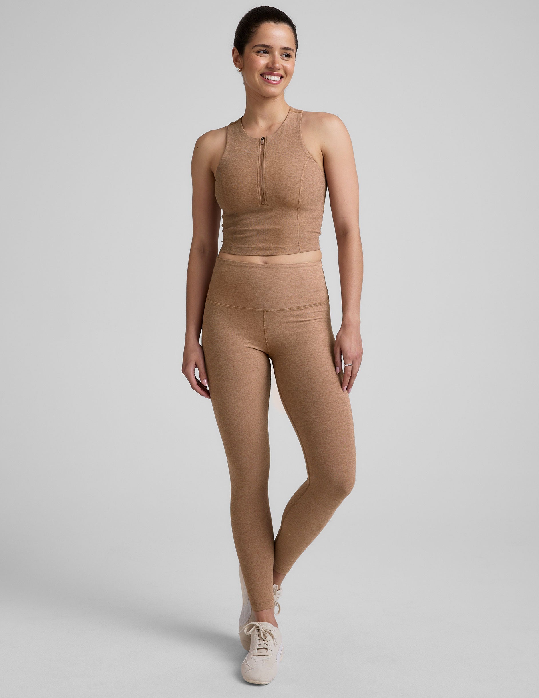 full body image of a brown racerback cropped tank with a half zip up detail in front.