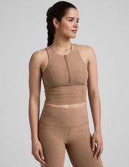 side image of a brown racerback cropped tank with a half zip up detail in front.