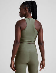 back image of a green racerback cropped tank with a half zip up detail in front.