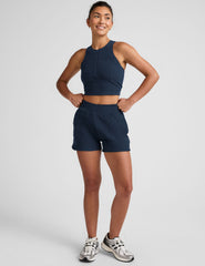 blue cropped tank with a high neck with center front zipper.