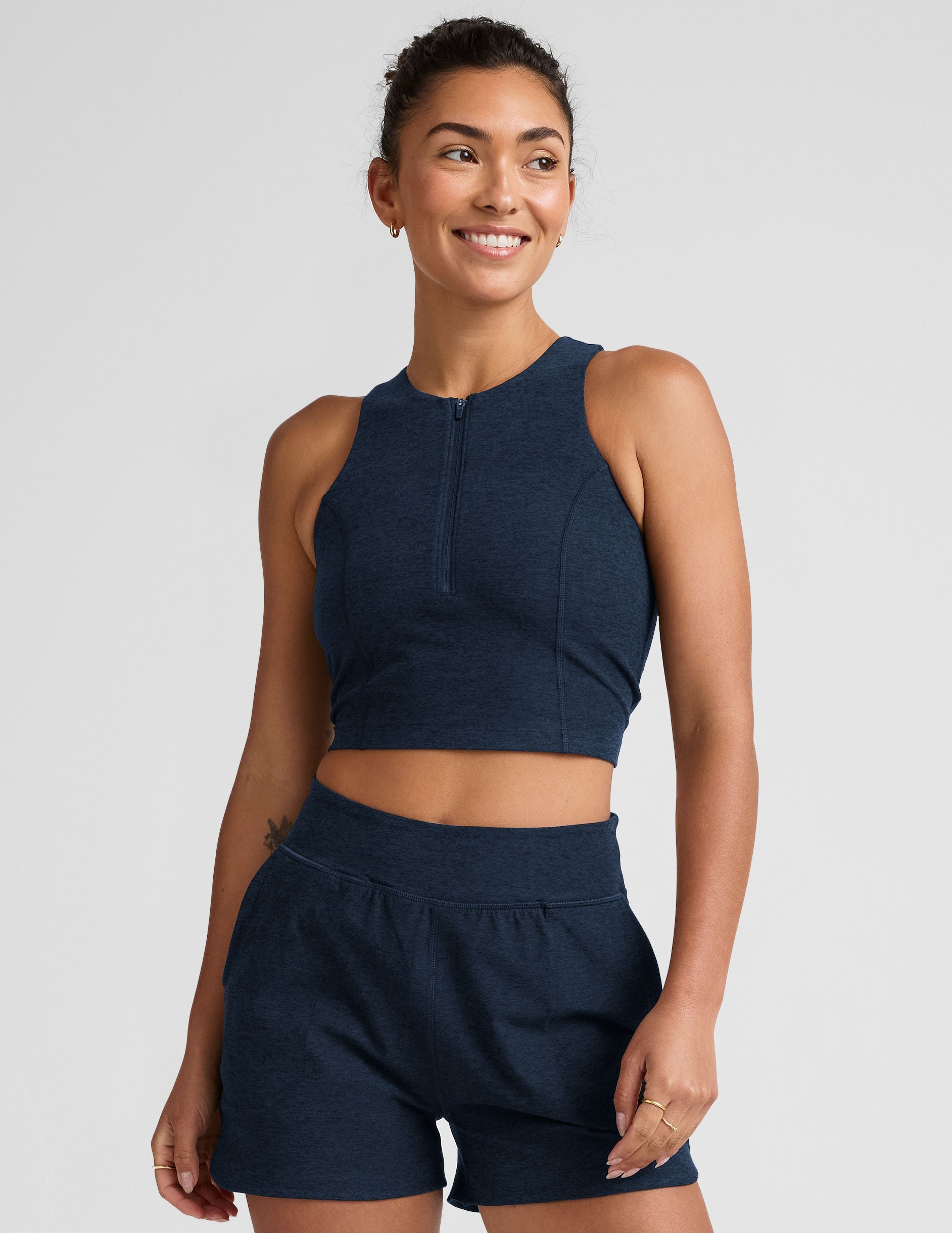 blue cropped tank with a high neck with center front zipper.