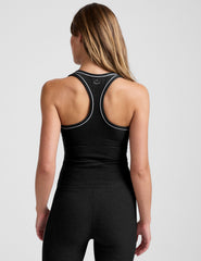 model is wearing a black midway length scoop neck racerback tank top with white contrast trim.