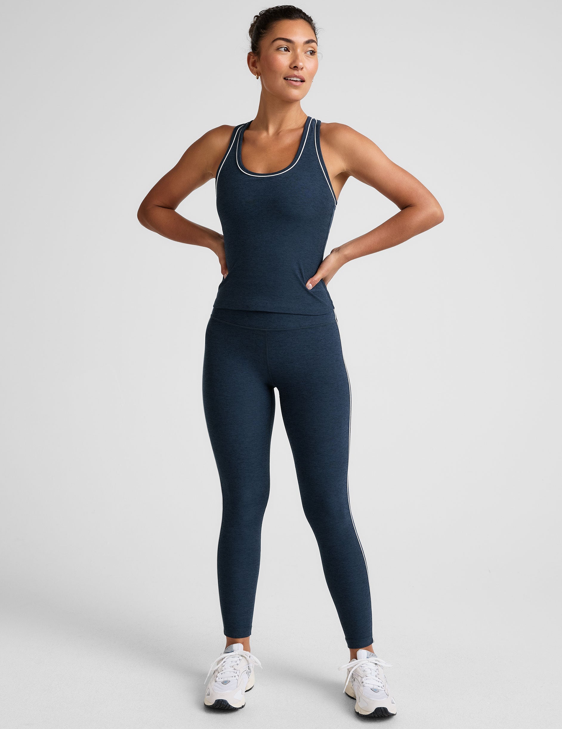 blue midway length racerback tank with white contrast trim.