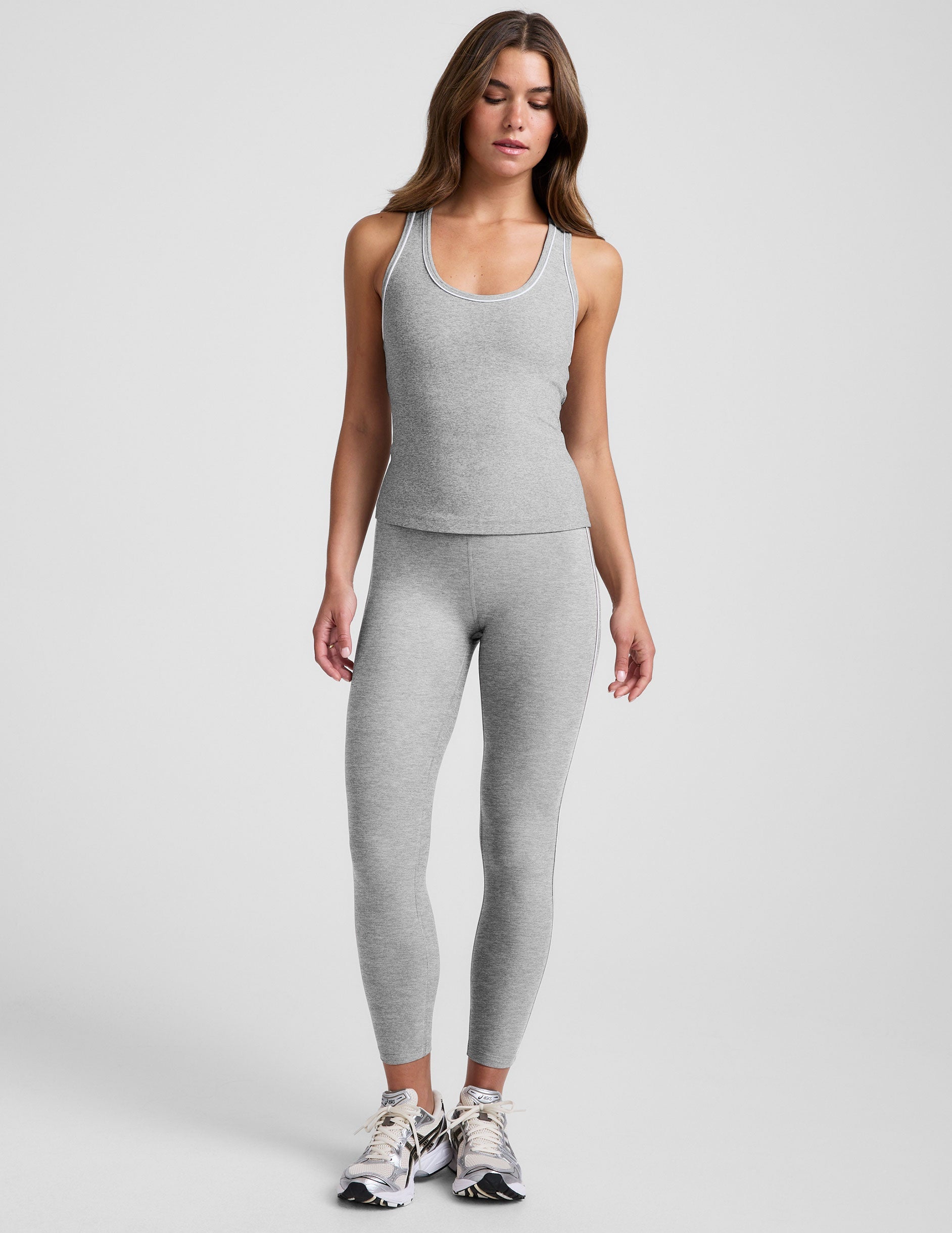 grey midway length racerback tank with white contrast trim.