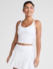 white waist length, V neckline​ tank top with a self shelf bra and criss-cross strap back detail​. 