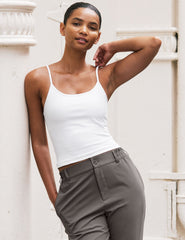 white midway length tank with adjustable spaghetti straps.