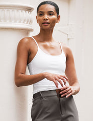 white midway length tank with adjustable spaghetti straps.