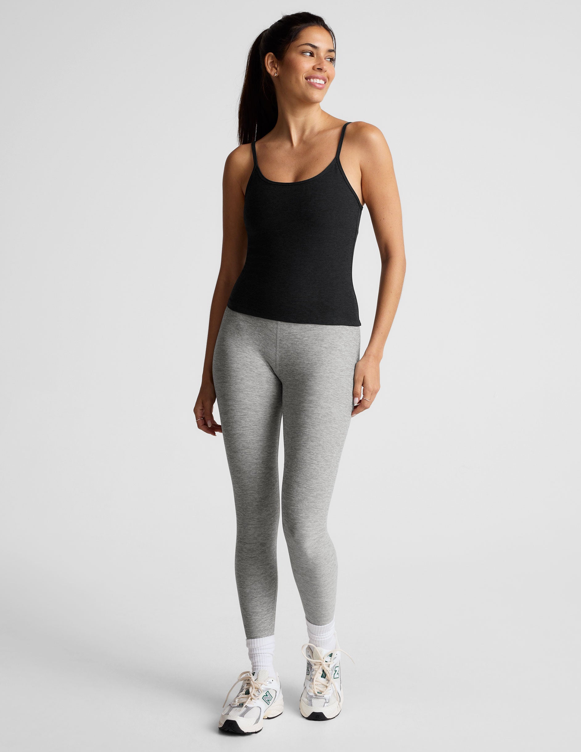 black midway length tank top with adjustable spaghetti straps.