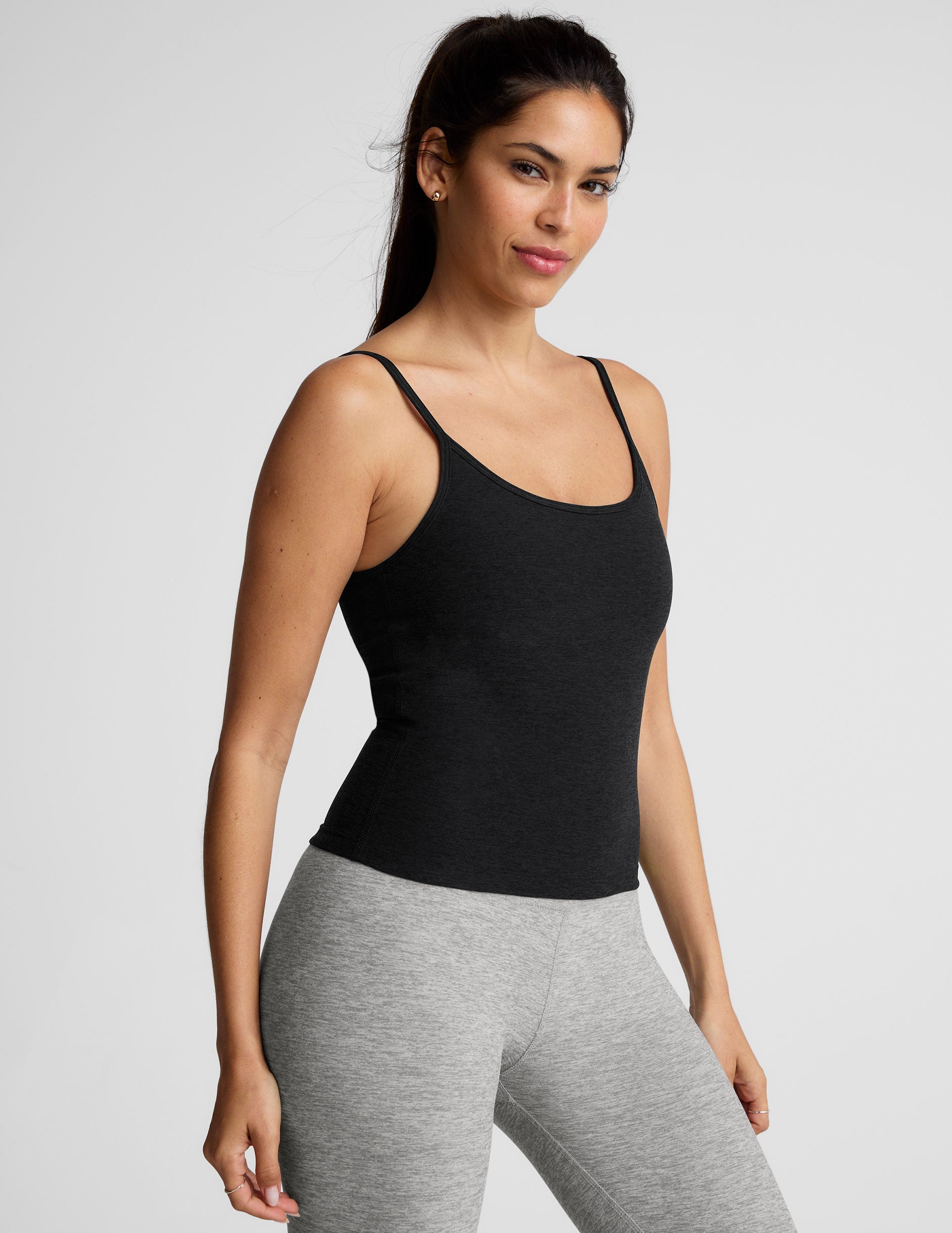 black midway length tank top with adjustable spaghetti straps.