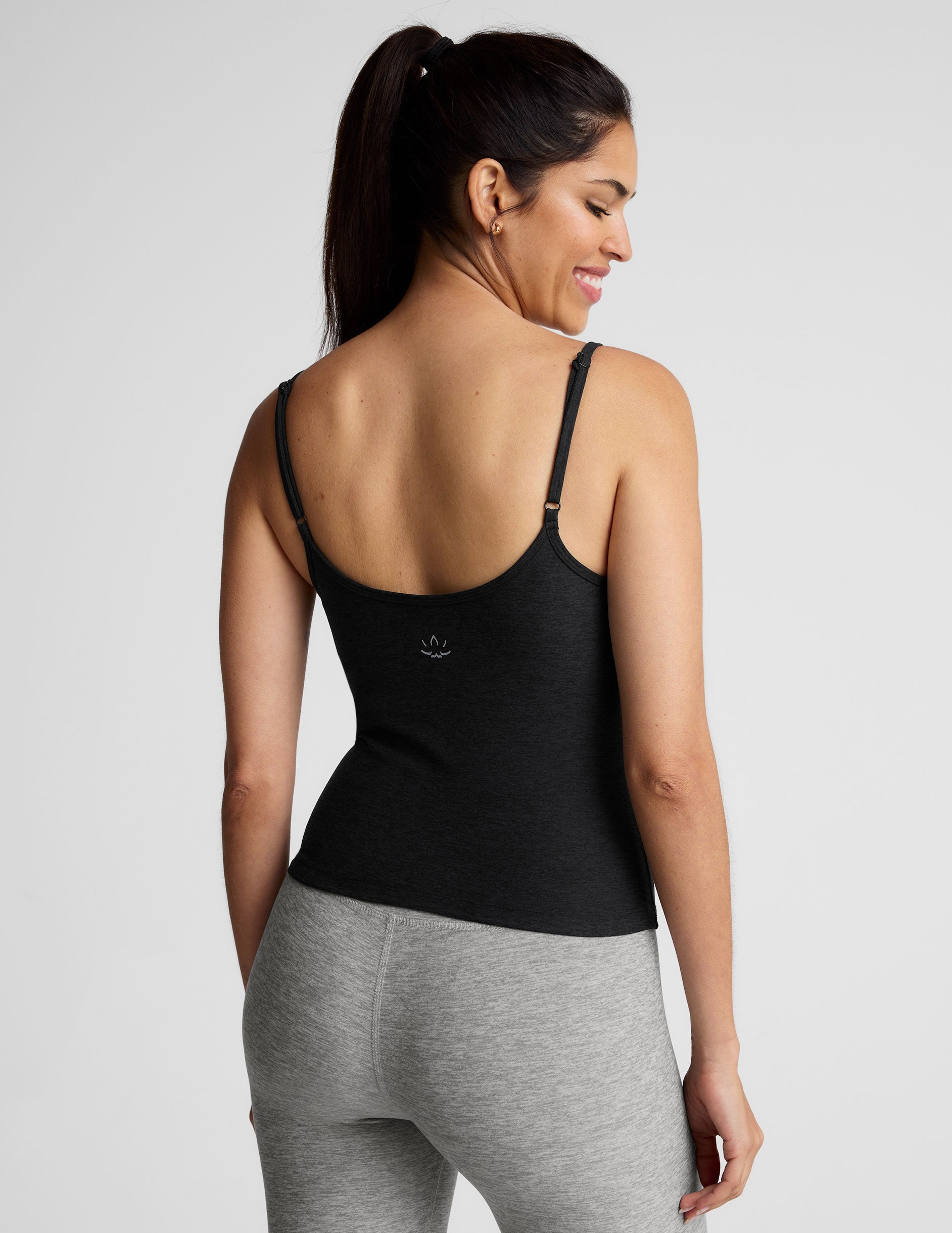 black midway length tank top with adjustable spaghetti straps.