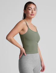 green waist length tank top with adjustable straps.