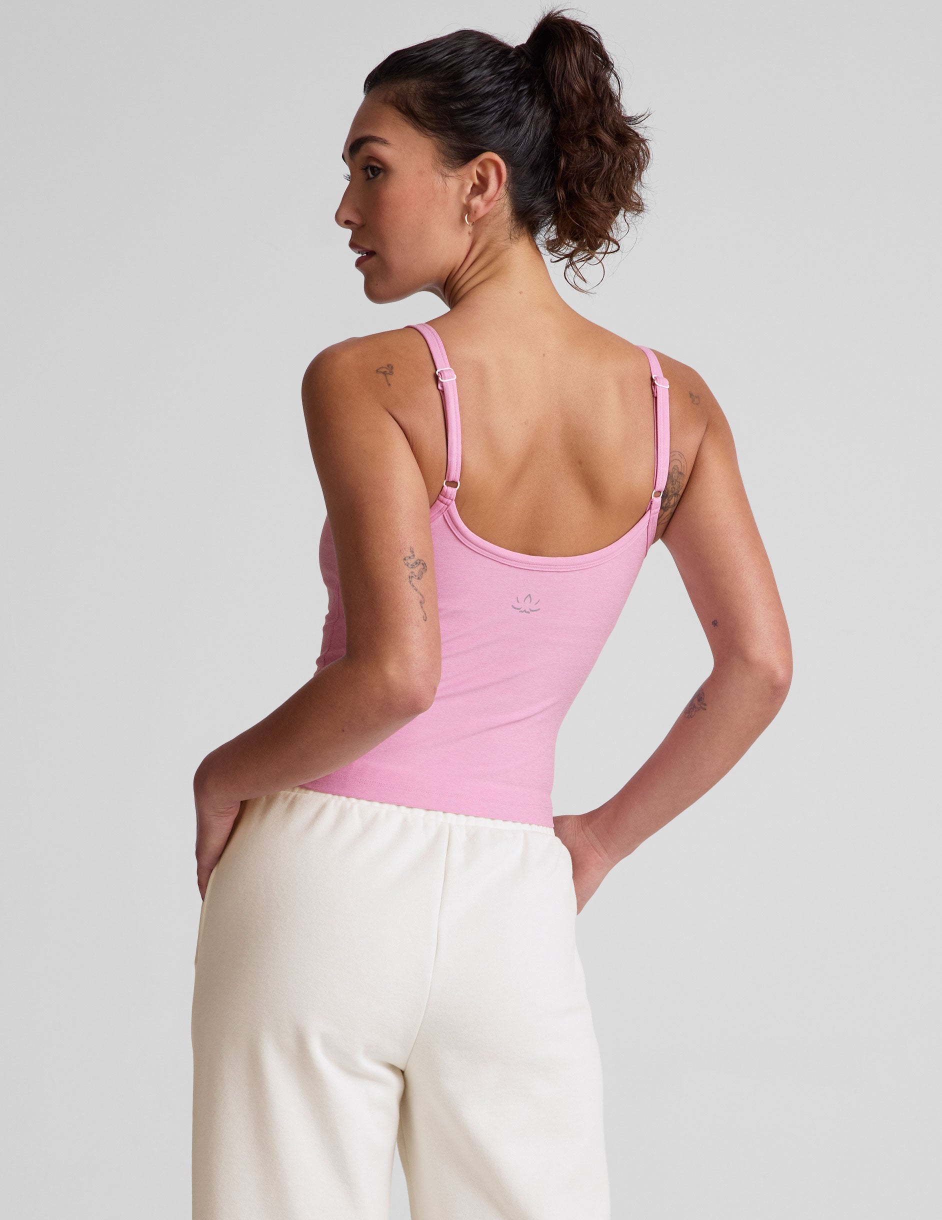 pink waist length tank with adjustable spaghetti straps.