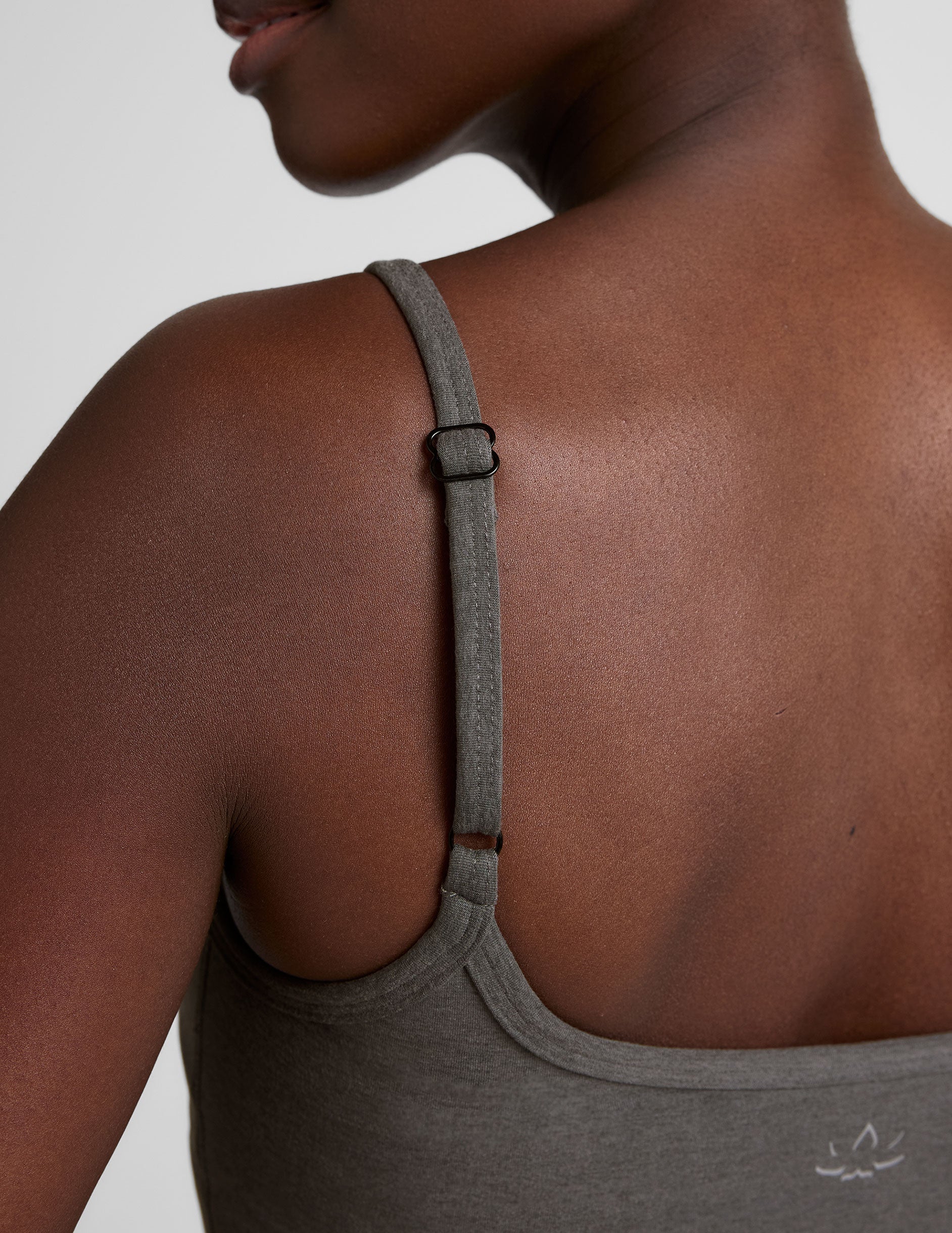 gray waist length tank with adjustable spaghetti straps.