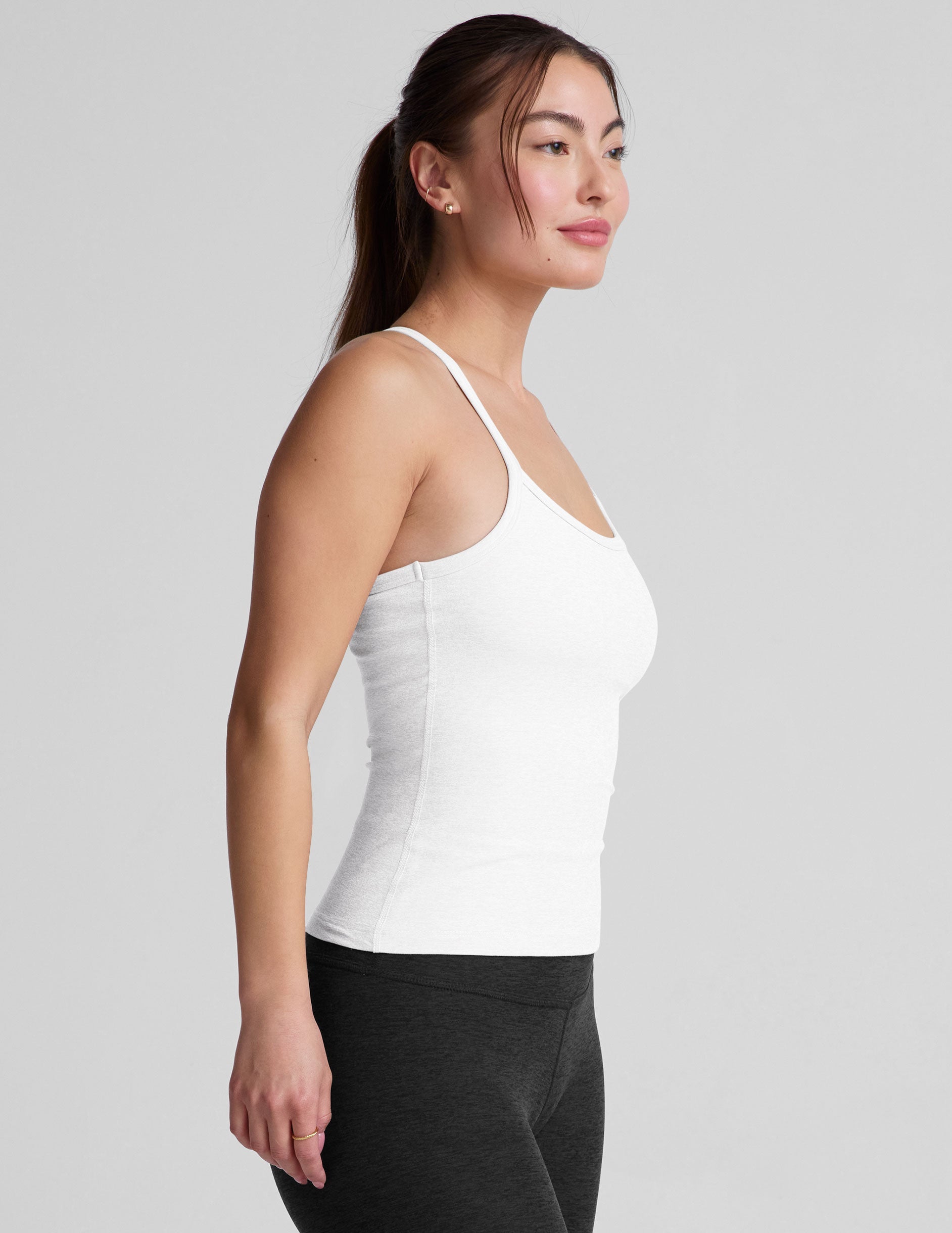 white midway length tank with adjustable spaghetti straps.