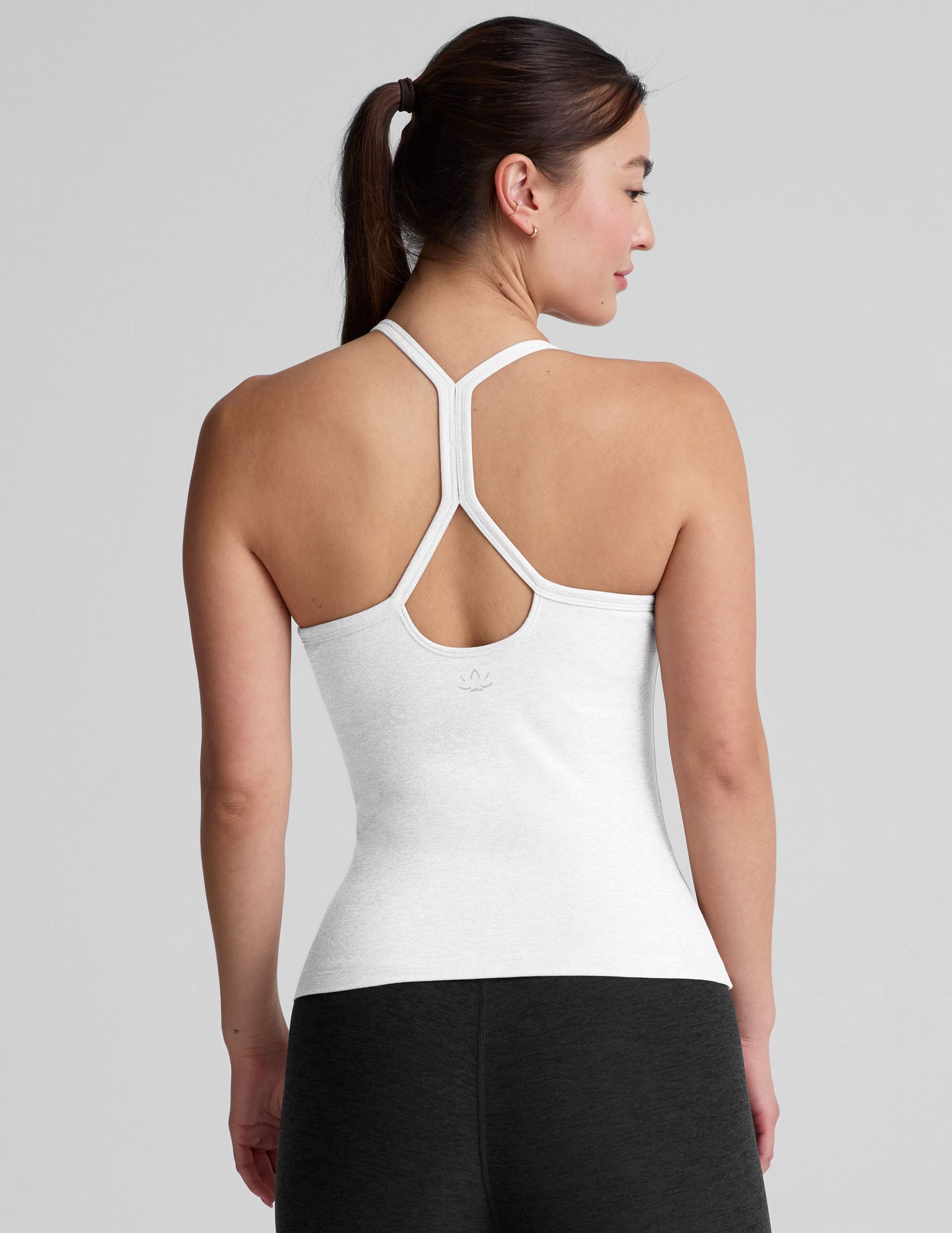 white midway length tank with adjustable spaghetti straps.
