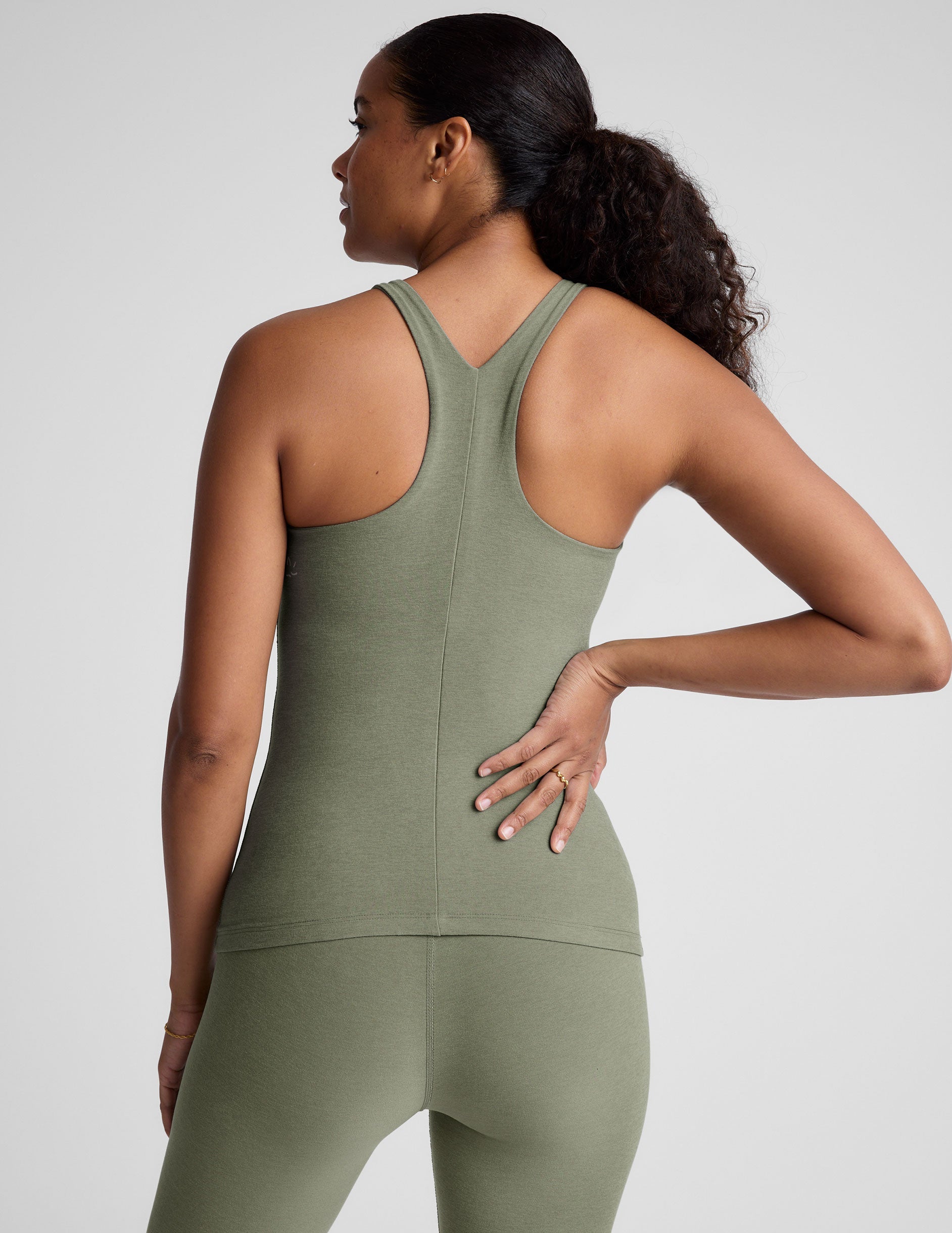 grey classic length racerback tank top with a high scoop neckline.
