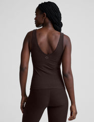 model wearing a brown full length tank top and leggings against a plain background.