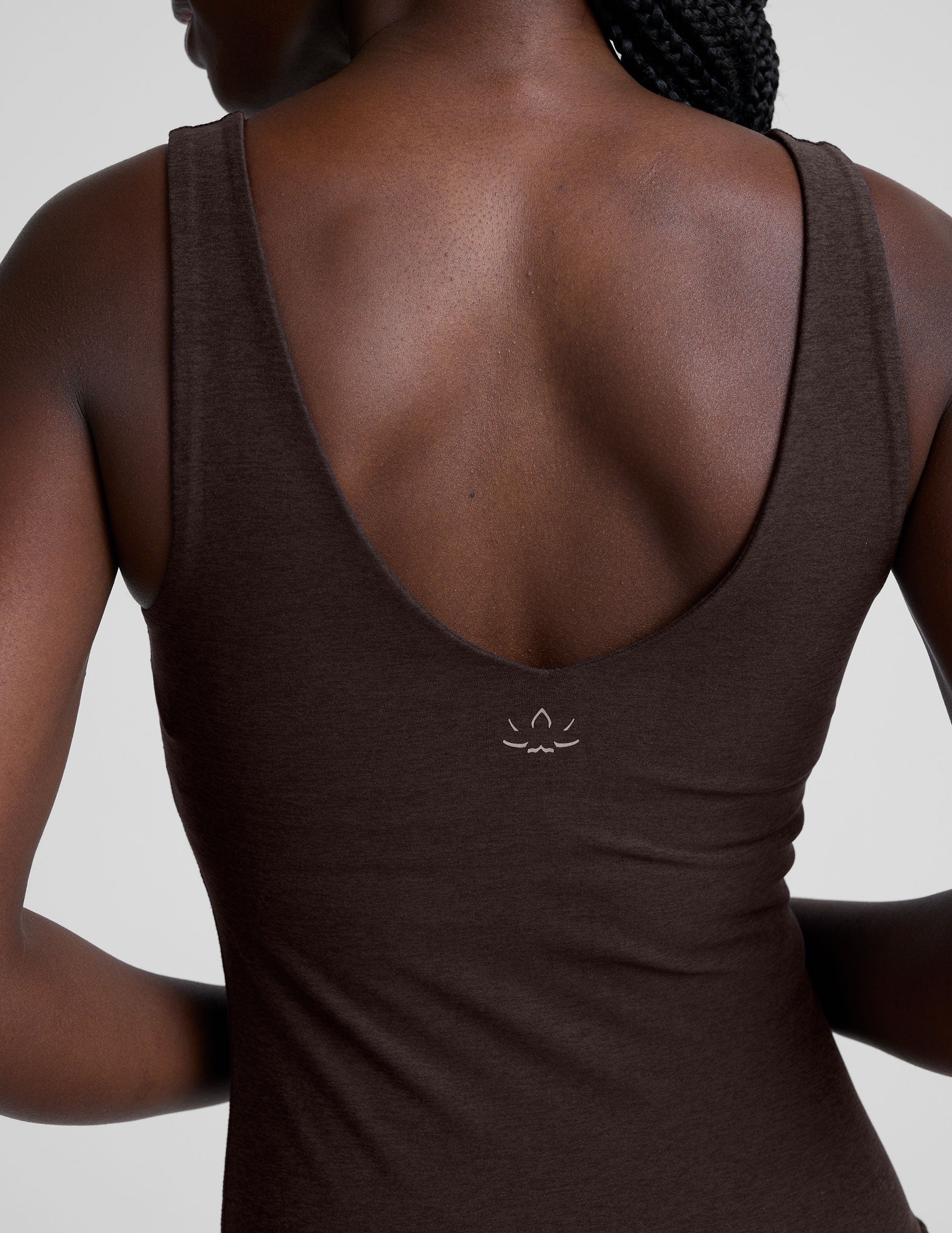 model wearing a brown full length tank top and leggings against a plain background.