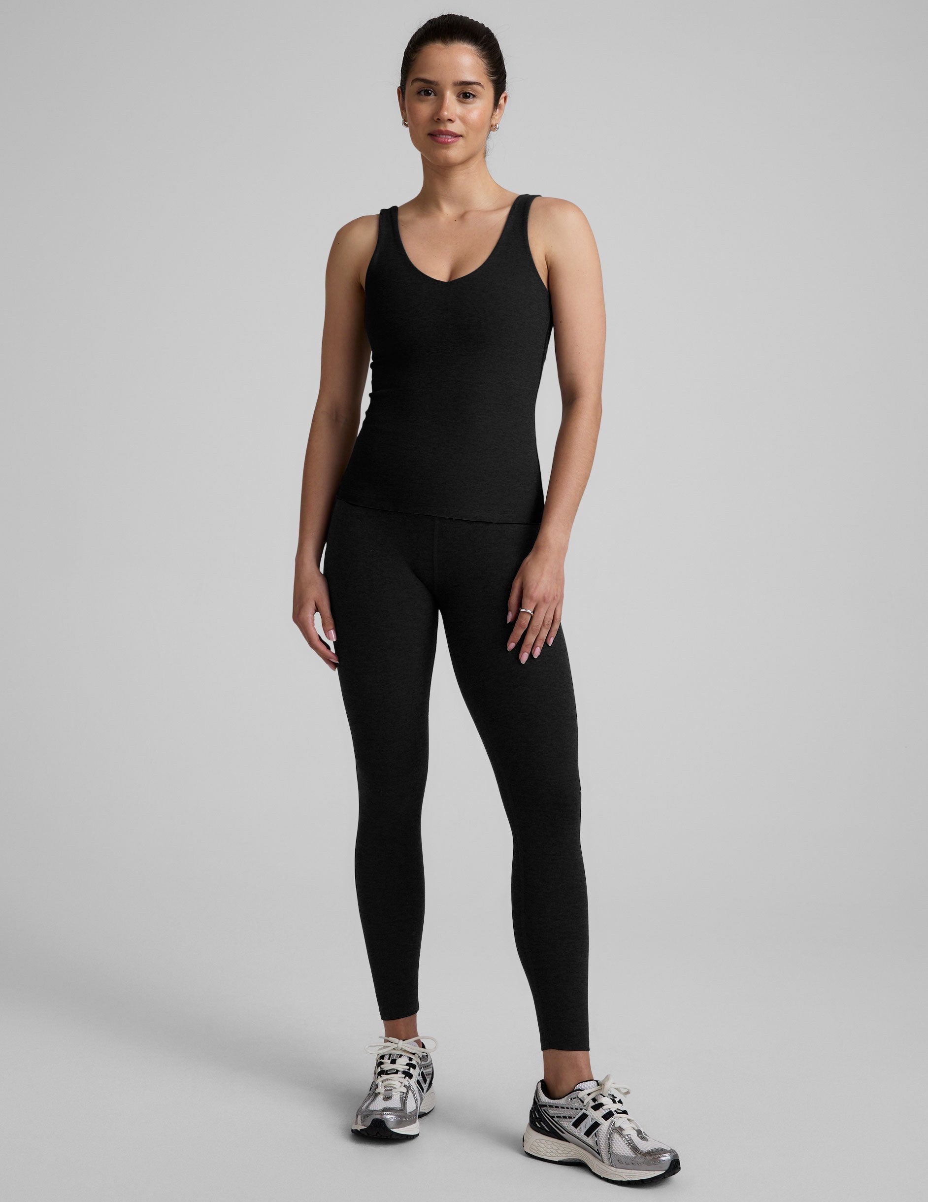 black waist length tank top with a front and back v neckline.