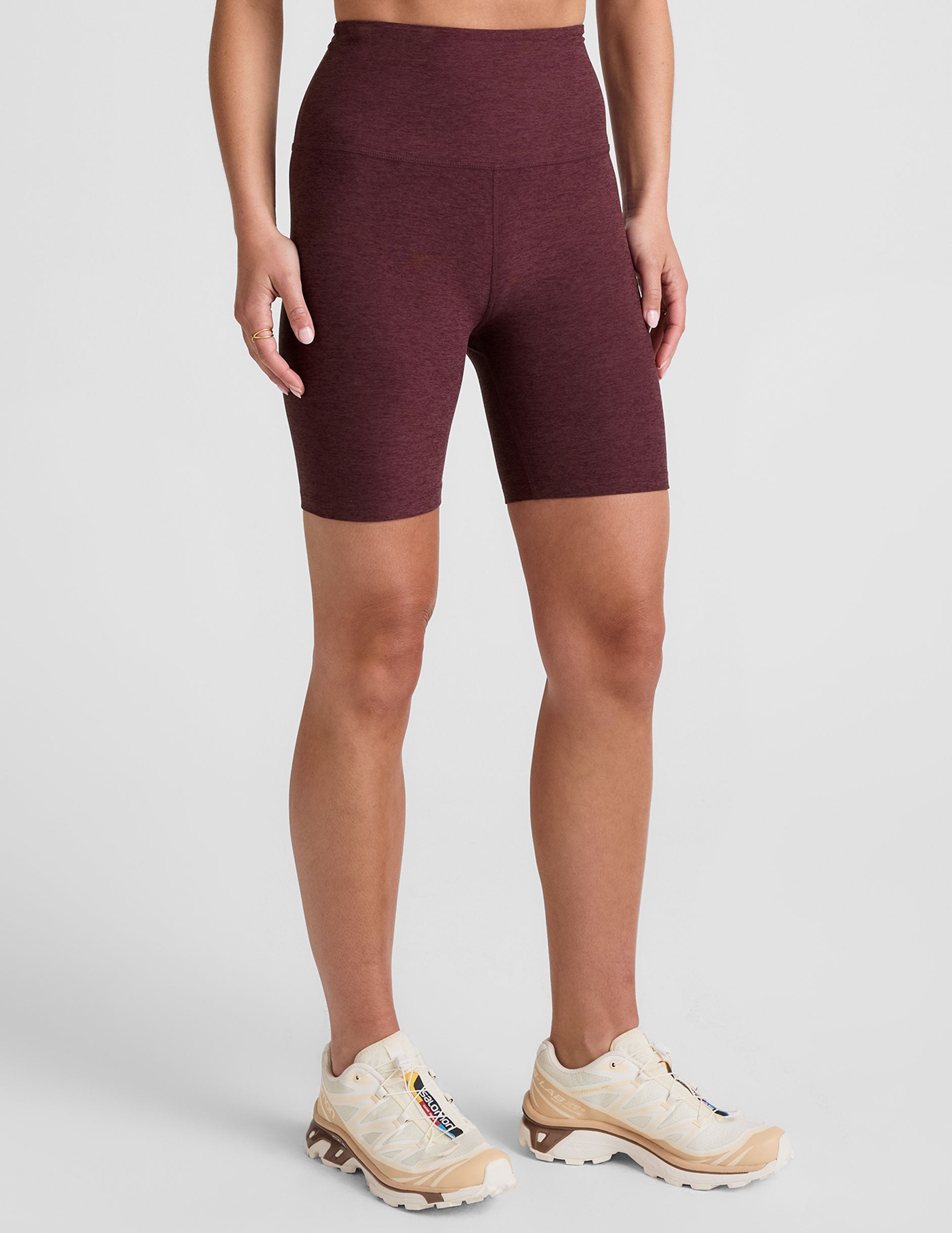 model is wearing red high-waisted 7" inseam biker shorts. 