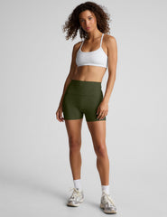 model is wearing green high-waisted 3" inseam shorts. 